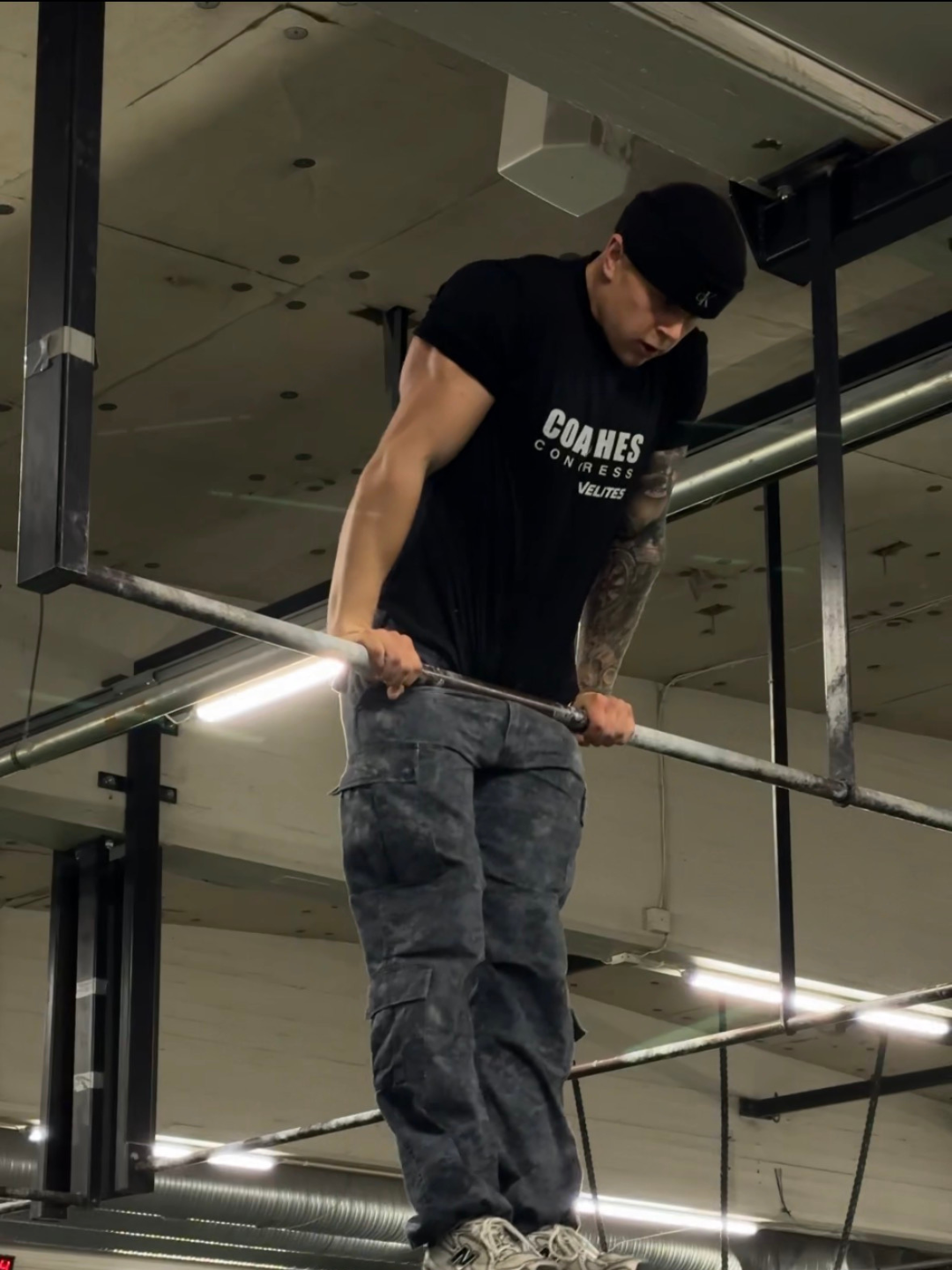 Coach performing a muscle-up